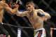 Apr 19, 2014; Orlando, FL, USA; Rafael dos Anjos (red gloves) fights Khabib Nurmagomedov (blue gloves) in their lightweight fight during UFC on FOX 11 at Amway Center. Mandatory Credit: David Manning-USA TODAY Sports
