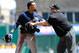 Milwaukee Brewers' Carlos Gomez (27) tries to get past umpire Fieldin Culbreth, center, Pittsburgh Pirates third baseman Josh Harrison (5) to get to Pittsburgh Pirates starting pitcher Gerrit Cole during the third inning of a baseball game in Pittsburgh Sunday, April 20, 2014. A dugouts clearing brawl ensued, with Gomez at the center, causing him to be ejected from the game. (AP Photo/Gene J. Puskar)