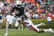 Auburn DB Brandon King (29) tackles WR "Duke" Williams (1)