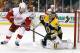 Boston Bruins goalie Tuukka Rask, right, makes a glove-save as Detroit Red Wings' Justin Abdelkader (8) looks for a rebound during the third period of Boston's 4-1 win in Game 2 of a first-round NHL hockey playoff series in Boston, Sunday, April 20, 2014. (AP Photo/Winslow Townson)