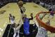 Dallas Mavericks' Monta Ellis (11) drives to the basket between San Antonio Spurs' Matt Bonner, left, and Tim Duncan, right, during the first quarter of Game 1 of the opening-round NBA basketball playoff series, Sunday, April 20, 2014, in San Antonio. (AP Photo/Eric Gay)