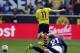 Dortmund's Marco Reus, rear, and Mainz goalkeeper Loris Karius challenge for the ball during the German first division Bundesliga soccer match between BvB Borussia Dortmund and Mainz 05 in Dortmund, Germany, Saturday, April 19, 2014. (AP Photo/Frank Augstein)