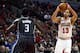 Chicago Bulls center Joakim Noah (13) shoots over Orlando Magic center Dewayne Dedmon (3) during the second half of an NBA basketball game Monday, April 14, 2014, in Chicago. The Bulls won the game 108-95. (AP Photo/Jeff Haynes)