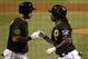 Pittsburgh Pirates' Andrew McCutchen, right, is greeted by teammate Pedro Alvarez as he returns to the dugout after hitting a solo home run off Cincinnati Reds starting pitcher Johnny Cueto during the ninth inning of a baseball game in Pittsburgh Tuesday, April 22, 2014. Cueto 3-hit the Pirates for the second time in a week, and the Reds won 4-1.(AP Photo/Gene J. Puskar)
