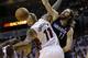 Charlotte Bobcats' Josh McRoberts (11) shoots over Miami Heat's Chris Andersen (11) during the second half in Game 1 of an opening-round NBA basketball playoff series, Sunday, April 20, 2014, in Miami. The Heat defeated the Bobcats 99-88. (AP Photo/Lynne Sladky)
