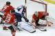Chicago Blackhawks goalie Corey Crawford (50) makes a save on a shot by Winnipeg Jets defenseman Zach Bogosian (44) as Sheldon Brookbank (17) and Kris Versteeg (23) defend during the first period of an NHL hockey game Sunday, Jan. 26, 2014, in Chicago. (AP Photo/Charlie Arbogast)