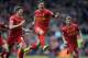 Liverpool's Philippe Coutinho, centre, celebrates with teammate Steven Gerrard, left, after he scored the third goal of the game for his side during their English Premier League soccer match against Manchester City at Anfield in Liverpool, England, Sunday April. 13, 2014. (AP Photo/Clint Hughes)