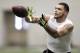 Texas A&M wide receiver Mike Evans catches a pass from quarterback Johnny Manziel during a drill at pro day for NFL football representatives in College Station, Texas, Thursday, March 27, 2014. (AP Photo/Patric Schneider)