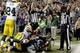 FILE - In this Sept. 24, 2012, file photo, an official, rear center, signals for a touchdown by Seattle Seahawks wide receiver Golden Tate, obscured, as another official, at right, signals a touchback on the controversial last play of an NFL football game against the Green Bay Packers in Seattle. The Seahawks won 14-12. The NFL and the referees' union have reached a tentative contract agreement on Wednesday, Sept. 26, ending an impasse that began in June when the league locked out the officials and used replacements instead. (AP Photo/Stephen Brashear, File)