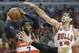 Washington Wizards guard John Wall (2), left, looks to a pass against the Chicago Bulls during the first half in Game 1 of an opening-round NBA basketball playoff series in Chicago, Sunday, April 20, 2014. (AP Photo/Nam Y. Huh)
