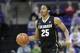 Spencer Dinwiddie dribbles up court against Washington in the first half of an NCAA men's basketball game Sunday, Jan. 12, 2014, in Seattle. (AP Photo/Elaine Thompson)