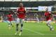 HULL, ENGLAND - APRIL 20: Lukas Podolski (C) of Arsenal celebrates with team mates Olivier Giroud (R) and Bacary Sagna (L) after scoring his sides third goal during the Barclays Premier League match between Hull City and Arsenal at KC Stadium on April 20, 2014 in Hull, England. (Photo by Matthew Lewis/Getty Images)