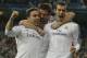 Real's Gareth Bale, right, celebrates scoring the opening goal with Real's Daniel Carvajal, left, and Xabi Alonso, center, during a Champions League quarterfinal first leg soccer match between Real Madrid and Borussia Dortmund at the Santiago Bernabeu stadium in Madrid, Spain, Wednesday April 2, 2014. (AP Photo/Paul White)