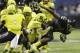 U.S. Army All-American East's Sony Michel (1) is stopped by U.S. Army All-American West's Nyles Morgan, center, during the U.S. Army All-American Bowl football game, Saturday, Jan. 4, 2014, in San Antonio. (AP Photo/Eric Gay)