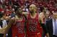 Chicago Bulls guard Jimmy Butler (21) is pulled away by forward Taj Gibson (22) after an altercation with Washington Wizards forward Nene (42), from Brazil, in the second half of Game 3 of an opening-round NBA basketball playoff series on Friday, April 25, 2014, in Washington. Nene received a double technical and was ejected. The Bulls won 100-97. (AP Photo/Alex Brandon)