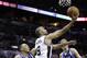 San Antonio Spurs' Tony Parker (9), of France, shoots around Dallas Mavericks' Shawn Marion, left, and Dirk Nowitzki (41), of Germany, during the first half of Game 2 of the opening-round NBA basketball playoff series on Wednesday, April 23, 2014, in San Antonio. (AP Photo/Eric Gay)