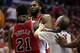 Referee Jason Phillips moves to separate Chicago Bulls guard Jimmy Butler (21) and Washington Wizards forward Nene, center, from Brazil, in the second half of Game 3 of an opening-round NBA basketball playoff series on Friday, April 25, 2014, in Washington. Nene received a double technical and was ejected. The Bulls won 100-97. (AP Photo/Alex Brandon)