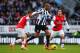 NEWCASTLE UPON TYNE, ENGLAND - DECEMBER 29: Loic Remy of Newcastle United is closed down by Jack Wilshere (L) and Tomas Rosicky of Arsenal during the Barclays Premier League match between Newcastle United and Arsenal at St James' Park on December 29, 2013 in Newcastle upon Tyne, England. (Photo by Michael Regan/Getty Images)