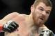 Jim Miller, left, of Whippany, N.Y., and Fabricio Camoes, of San Diego, Calif., battle during a UFC 168 mixed martial arts lightweight bout on Saturday, Dec. 28, 2013, in Las Vegas. Miller won by a tap out in the first round. (AP Photo/David Becker)