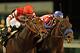 Bayern, right, ridden by Rosie Napravnik, battles Embellishing Bob, left, ridden by Brian Hernandez Jr., at the wire in Derby Trial horse race at Churchill Downs in Louisville, Ky., Saturday, April 26, 2014. Bayern finished first, but was disqualified and placed second for interference in the stretch and Embellishing Bob was awarded the victory. (AP Photo/Garry Jones)