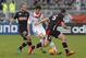 Lyon's Yoann Gourcuff, center, challenges for the ball with Monaco's Valere Germain, left, and Jessy Pi, right, during their French League One soccer match in Lyon, central France, Sunday, March 16, 2014. (AP Photo/Laurent Cipriani)