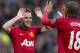 Manchester United's Juan Mata, left, celebrates with teammate Ashley Young after scoring his second goal against Norwich City during their English Premier League soccer match at Old Trafford Stadium, Manchester, England, Saturday April 26, 2014. (AP Photo/Jon Super)