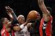 Toronto Raptors forward Patrick Patterson (54) and Raptors forward Amir Johnson (15) defend Brooklyn Nets forward Paul Pierce (34) as pierce goes up for a layup in the second half of Game 4 of an NBA basketball first-round playoff series at the Barclays Center, Sunday, April 27, 2014, in New York. The Raptors evened the series at 2-2 defeating the Nets 87-79. (AP Photo/Kathy Willens)