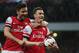 Arsenal's Laurent Koscielny, right, celebrates with teammate Oliver Giroud after scoring the opening goal during their English Premier League soccer match between Arsenal and Newcastle United at the Emirates stadium in London, Monday, April 28, 2014. (AP Photo/Alastair Grant)