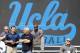 UCLA head coach Jim Mora, left, talks with an NFL scout from the Nashville Titans during UCLA pro day at Spaulding Field on Tuesday, March 11, 2014, in Los Angeles. (AP Photo/Alex Gallardo)