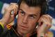 Real Madrid's Gareth Bale adjusts his headset during a news conference prior to the Champions League semifinal soccer match between FC Bayern Munich and Real Madrid, in Munich, southern Germany, Monday, April 28, 2014. Real Madrid will play Bayern Munich in a Champions League semifinal second leg soccer match on Tuesday. (AP Photo/Matthias Schrader)