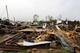 Residents sift through the debris after a tornado passed through destroying Billy Barbs mobile home park on Tuesday, April 29, 2014, in Athens, Ala. A dangerous storm system that spawned a chain of deadly tornadoes over three days flattened homes and businesses, forced frightened residents in more than half a dozen states to take cover and left tens of thousands in the dark Tuesday morning.(AP Photo/Butch Dill)