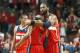 Washington Wizards forward Nene Hilario, right, hugs guard John Wall in the closing seconds of the second half of Game 5 in an opening-round NBA basketball playoff series against the Chicago Bulls, Tuesday, April 29, 2014, in Chicago. The Wizards eliminated the Bulls winning 75-69. (AP Photo/Charles Rex Arbogast)
