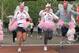 Runners in costume cross the finish line of the 26.2 mile Flying Pig Marathon race in Cincinnati, Sunday, May 7, 2006. (AP Photo/Tom Uhlman)