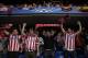 Supporters of Atletico wave their flags and scarfs as they sing waiting for the start of the Champions League semifinal second leg soccer match between Chelsea and Atletico Madrid at Stamford Bridge stadium in London, Wednesday, April 30, 2014. (AP Photo/Matt Dunham)