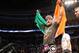 Conor McGregor, of Ireland, leaves the ring draped in an Irish flag after beathing Max Holloway in their UFC on Fox Sports 1 mixed martial arts bout in Boston, Saturday, August 17,2013. McGregor won via unanimous decision. (AP Photo/Gregory Payan)