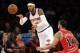New York Knicks' Carmelo Anthony, left, passes the ball past Chicago Bulls' D.J. Augustin during the first half of the NBA basketball game, Sunday, April 13, 2014 in New York. The Knicks defeated the Bulls 100-89. (AP Photo/Seth Wenig)