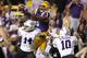 LSU wide receiver Odell Beckham (3) pulls in a reception for a 37-yard touchdown over Furman cornerback Reggie Thomas (14) and safety Marcus McMorris (10) during the second quarter of the NCAA college football game in Baton Rouge, La., Saturday, Oct, 26, 2013. (AP Photo/Jonathan Bachman)
