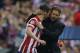 Atletico's Adrian Lopez is hugged by Atletico's coach Diego Simeone during the Champions League quarterfinal second leg soccer match between Atletico Madrid and FC Barcelona at the Vicente Calderon stadium in Madrid, Spain, Wednesday, April 9, 2014. (AP Photo/Andres Kudacki)