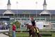 Exercise rider William Delgado takes Kentucky Derby entrant California Chrome for a morning workout at Churchill Downs Thursday, May 1, 2014, in Louisville, Ky. (AP Photo/Charlie Riedel)
