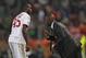 AC Milan's Mario Balotelli, left, talks with coach Clarence Seedorf during an Italian Serie A soccer match between Roma and AC Milan at Rome's Olympic stadium, Friday, April 25, 2014. (AP Photo/Alessandra Tarantino)