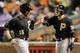 Pittsburgh Pirates' Ike Davis, left, fist-bumps teammate Clint Barmes after scoring on a bases-loaded walk to Neil Walker in the first inning of the second baseball game of a doubleheader against the Baltimore Orioles, Thursday, May 1, 2014, in Baltimore. (AP Photo/Patrick Semansky)