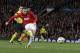Manchester United's Wayne Rooney shoots a ball during the Champions League quarterfinal first leg soccer match between Manchester United and Bayern Munich at Old Trafford Stadium, Manchester, England, Tuesday, April 1, 2014.(AP Photo/Jon Super)