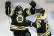 Boston Bruins defenseman Johnny Boychuk, left, raises his arms as he celebrates his tying goal, which forced the game into overtime, against the Montreal Canadiens during the third period of Game 1 in the second-round of the Stanley Cup playoff series in Boston, Thursday, May 1, 2014. At right is center Brad Marchand. (AP Photo/Charles Krupa)