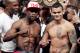 Floyd Mayweather Jr., left, poses on the scales with Marcos Maidana during the official weigh-in at the MGM Grand Hotel in Las Vegas, Friday, May 2, 2014. Mayweather is to face Maidana in a welterweight title fight on Saturday. (AP Photo/Chris Carlson)