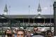 Fans look at a large video board before the 140th running of the Kentucky Derby horse race at Churchill Downs Saturday, May 3, 2014, in Louisville, Ky. (AP Photo/David Goldman)