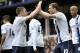 Manchester City's Edin Dzeko, right, celebrates with teammate James Milner after scoring the second goal of the game during their English Premier League soccer match against Everton at Goodison Park in Liverpool, England, Saturday May 3, 2014. (AP Photo/Clint Hughes)