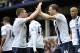 Manchester City's Edin Dzeko, right, celebrates with teammate James Milner after scoring the second goal of the game during their English Premier League soccer match against Everton at Goodison Park in Liverpool, England, Saturday May 3, 2014. (AP Photo/Clint Hughes)