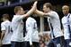 Manchester City's Edin Dzeko, right, celebrates with teammate James Milner after scoring the second goal of the game during their English Premier League soccer match against Everton at Goodison Park in Liverpool, England, Saturday May 3, 2014. (AP Photo/Clint Hughes)