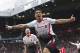 Liverpool's Luis Suarez celebrates after scoring against Manchester United, during their English Premier League soccer match at Old Trafford Stadium, Manchester, England, Sunday, March 16, 2014. (AP Photo/Jon Super)