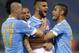 Napoli's Lorenzo Insigne, third from left, celebrates with teammates Marek Hamsik, left, Gokhan Inler, second from left, and Raul Albiol after scoring during the Italian Cup final match between Fiorentina and Napoli in Rome's Olympic stadium Saturday, May 3, 2014. (AP Photo/Gregorio Borgia)